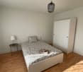 single bed, wardrobe, lamp on nightstand, wooden floor