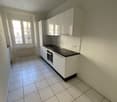 white cabinets, tiled floor, electric oven, black countertop, kitchen window