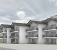 Modern apartment building with balconies, multiple floors, and a mountain view