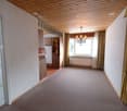 large empty room, wooden ceiling, chandelier, open doorway, tiled flooring, wooden cupboards, window, curtains