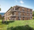 3-story modern residential building with balconies and a landscaped garden