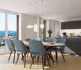 Dining table with 6 chairs, large windows, wooden floor, modern kitchen, view of the mountains