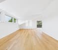 empty room, wooden floor, white walls, windows, slanted ceiling