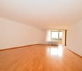 empty room, wooden floor, white walls, sliding glass door, balcony