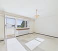 Empty room, glass door, sliding door, white walls, chandelier, white floor, radiator, balcony