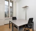 Modern interior with wooden floor, desk, chairs, floor lamp, window with view outside