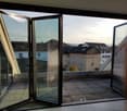 open sliding glass doors, balcony, tiled floor, view of the city