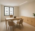 Spacious office with large windows, wooden desk and chairs, storage cabinet, and a potted plant.