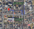 Urban area with buildings, road signs, and a campus.