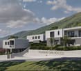 Modern houses, elevated ground floor, concrete walls, green landscape, mountain view