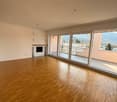 large open space, wooden floor, sliding glass doors, fireplace, balcony