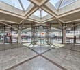 modern building, glass walls, revolving door, marble floor, glass ceiling