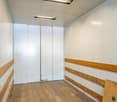 wooden floor, white walls, elevator, panel with buttons
