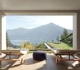 outdoor living area with two lounge chairs, mountain and lake view, patio furniture