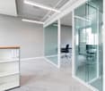 modern office room, glass walls, white walls, gray carpet, office desk, office chair, glass door