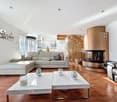 white walls, wooden floor, white sofa, fireplace, white coffee tables, lamps