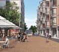 Pedestrian-friendly street with outdoor seating, shops, and residential buildings with balconies