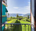balcony with railings, view of a lake and mountains