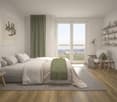 Spacious bedroom with large windows, white walls, hardwood floors, gray and green color scheme, king-size bed, bedside tables, shelves, and a comfortable armchair.