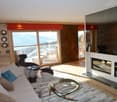 modern, wood wall, large windows, fireplace, coffee table, couch, armchair