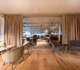 modern design, hardwood floors, glass partition, large windows, comfortable chairs, tables, lamps