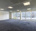 empty room, gray flooring, large windows, white walls