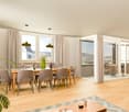 Dining room with wooden table, chairs, large windows, balcony, view of the outside