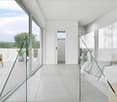 Minimalist style, modern bedroom with grey tiles, large windows, and balcony