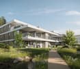 Modern design white building with glass walls on the lower levels and white walls on the upper levels. Multiple balconies with glass fences. A pathway leading to the entrance.