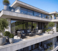 Modern house, concrete exterior, large glass windows, outdoor seating area, multiple balconies, greenery
