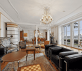 modern furniture, white walls, chandelier, wooden floor, fireplace, glass doors, view to the outside