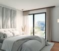Modern styled bedroom with bed, pillows, books on table, large white windows, and mountain view.