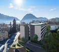 Modern apartment building with a view of the mountains and the city