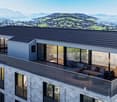 Modern apartment building with terrace, large windows, mountain view