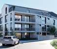 Modern apartment building with balconies, gray stone facade, large windows, car parked in front