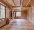wooden floor, wooden walls, large windows, built-in shelves, radiator