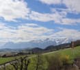 green grass, flag, road, houses, mountains