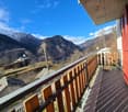 wooden railing, tiled floor, view of mountains