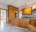 modern kitchen, wooden cabinets, granite countertops, built-in oven, stainless steel faucet