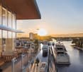 modern building, glass walls, balcony, view of the river, docked boats