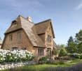2 story house, brick, thatched roof, garden, outdoor seating, trees