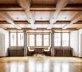 wooden floor, wooden ceiling, large windows, wooden table, wooden benches, radiators