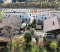 Three houses, two with solar panels on the roof, one with a swimming pool