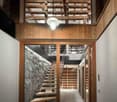 Wooden beamed ceiling, stone wall, wooden staircase, lighting fixture