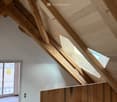 Ceiling with wooden beams, slanted wooden wall, skylights