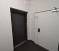 Empty hallway with elevator and door