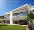 Modern house, white stone, large glass windows, outdoor dining area, garden, green grass, palm tree