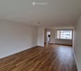 empty room, hardwood floor, white walls, window with white frames, lamps hanging from ceiling