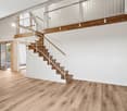 Modern house, wooden floors, white walls, glass doors, staircase, kitchen area, white cabinetry
