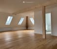 wooden floor, wooden beams, 3 attic windows, wooden support columns, open door